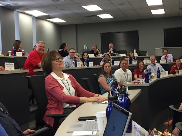 Attendees enjoy a light-hearted moment while sharing industry insights
